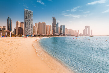 Luxurious sandy beach in the Dubai Marina area with views of the iconic skyscrapers and the warm...