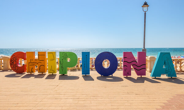 Chipiona, Cadiz, Spain - June 13, 2021: Multi Colored sign with the name of Chipiona at the access to one of its beaches, Cadiz, Andalucia, Spain