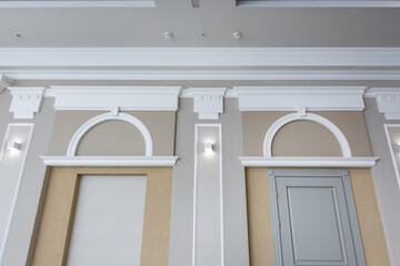 Detail of corner ceiling with intricate crown molding on column with spot light