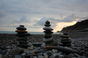 A tower of stones on the seashore. Cloudy weather.