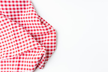 A crumpled dining tablecloth with a white and red checker isolated pattern is placed on a white background. Top view for food menu design. Used to cover the dining table, for easy to clean the table.
