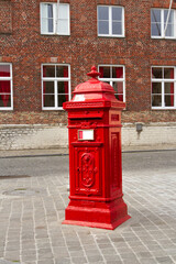 A typical traditional red mailbox, standing in the Belgian city of Bruges. Belgium