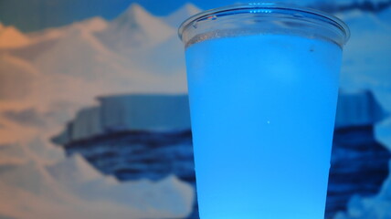 Frozen blue cocktail with a Antarctic glaciers panorama on the background