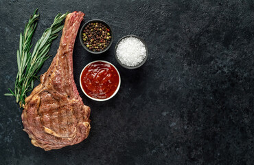 Grilled tomahawk steak on stone background with copy space for your text