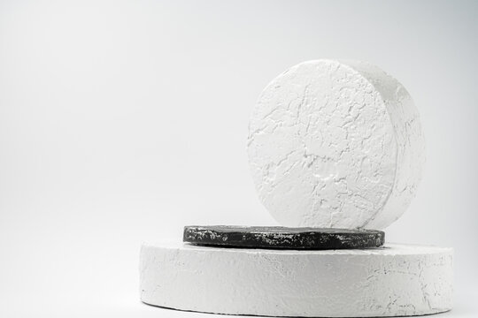 White And Black Round Pedestal Podium. Abstract Cement Pedestal By Spotlights On White Background