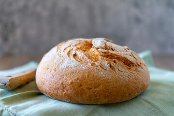 Rye bread lies on a light green textile and a gray background