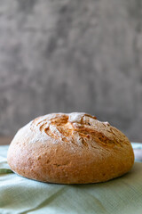Rye bread lies on a light green textile and a gray background