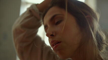 Fototapeta premium Creative woman creating masterpiece indoors. Tired painter wiping forehead.