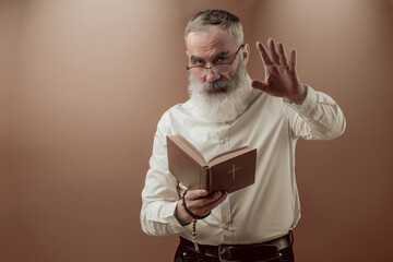 Senior charismatic man holding a book