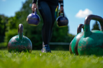 kettlebells in green grass - fitness concept outdoors  - 440321883