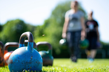 kettlebells in green grass - fitness concept outdoors  - 440322245
