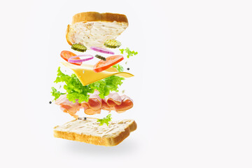 In the photo we see a sandwich with meat and various vegetables. Levitation. Abstraction. Light background. There is a place for your insert. No people. Light, pastel colors. - 440322274