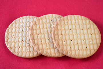 round wafer isolated on red background. Isolated dry cracker cookies. Isolated savory snacks.