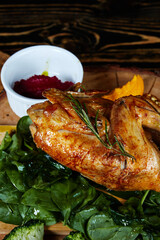 chicken broiler with herbs on a round wooden board