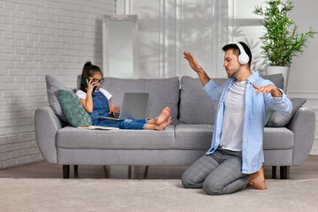 daughter learns using laptop and playful happy father dancing