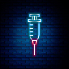 Glowing neon line Syringe icon isolated on brick wall background. Syringe for vaccine, vaccination, injection, flu shot. Medical equipment. Colorful outline concept. Vector