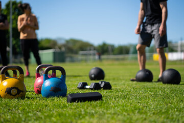 Kettlebell weightlifting. Group training after a lockdown outside the city. Get in shape - 440323846
