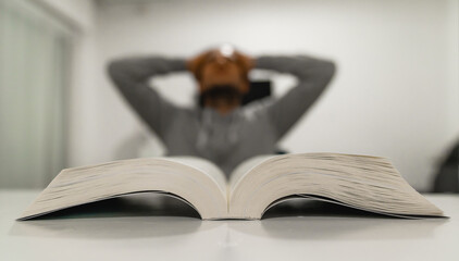tired student unable to focus on his book during quarantine