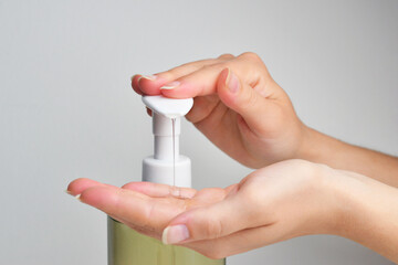 Using alcohol gel clean wash hand sanitizer anti virus bacteria dirty skin care. Closeup women use...