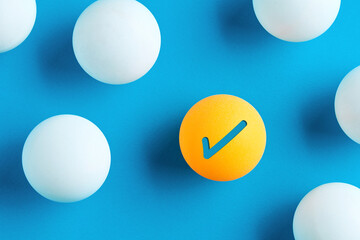 Check mark icon on yellow table tennis ball