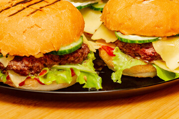home made burgers on wooden background. cheeseburger, burger, hamburger, beef