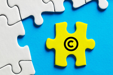 Copyright icon on a puzzle piece. Property and intellectual rights
