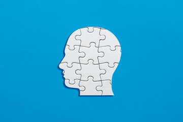 Human head symbol made out of puzzle pieces. Human psychology, mind complexity, schizophrenia or mental health