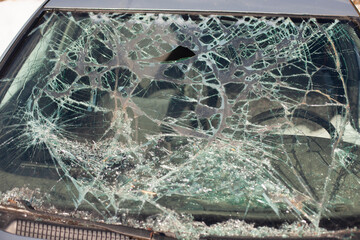 Broken car glass. The windshield cracked. Damaged transport.