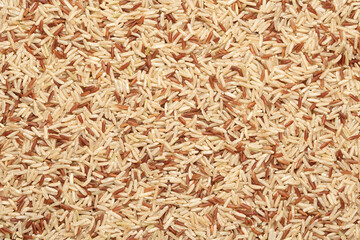 mix of brown and red rice. food background, texture