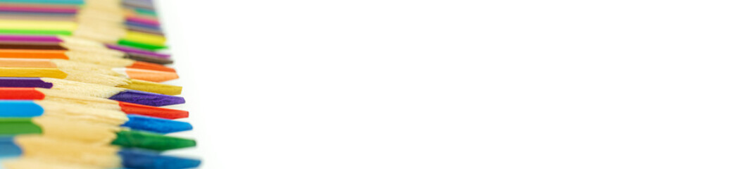 Banner with many colored pencils on a white isolated background, selective focus, copy space photo