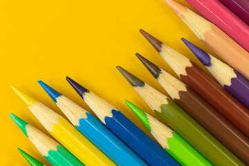 Ready to drawing concept background, color pencils on a yellow table background