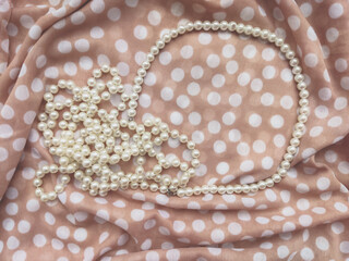 Beige background fabric textile dotted with white pearls 
