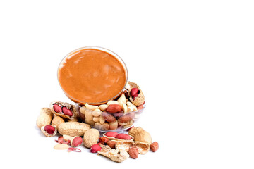 Peanut butter isolated and peanuts in the peel scattered on the white background. Copy space.