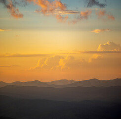 Silhouettes of the Carpathian mountains in the haze at sunset