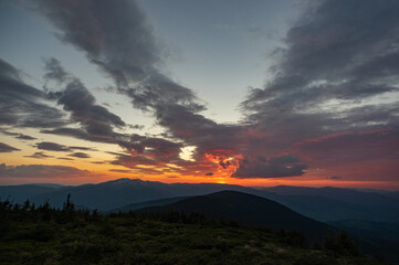 Naklejka na ściany i meble Beautiful colorful panorama of the sunset in the Carpathian mountains