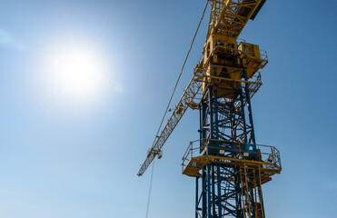 Industrial background,  crane against blue sky