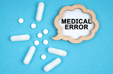 On a blue background, pills and a plate, inside which the inscription - MEDICAL ERROR