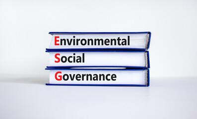 ESG environmental social governance symbol. Books with words ESG environmental social governance. Beautiful white background. Business and ESG environmental social governance concept. Copy space.