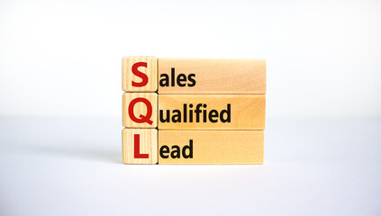SQL sales qualified lead symbol. Wooden blocks with words 'SQL sales qualified lead'. Beautiful...