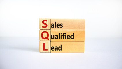 SQL sales qualified lead symbol. Wooden blocks with words 'SQL sales qualified lead'. Beautiful white background. Business and SQL sales qualified lead concept. Copy space.