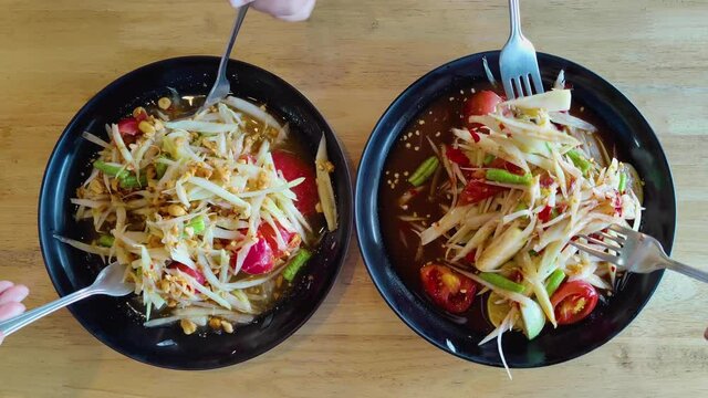 Papaya Salad, famous food of Thailand, Asia, the food is spicy because it contains green chili. Put beans with shrimp, healthy style, delicious taste, Thai people like to eat, family eating dinner
