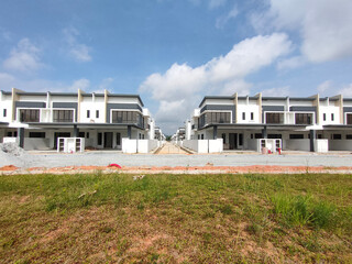 Fototapeta na wymiar SEREMBAN, MALAYSIA -JUNE 17, 2021: New double-story terrace house under construction in Malaysia. Designed by an architect with a modern and contemporary style. Almost completed. 