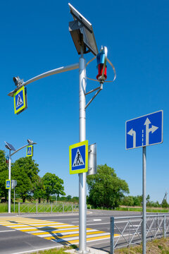 A pedestrian crossing equipped with an autonomous power supply system - a wind generator and a solar battery. Sunny day.