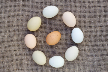 Raw farm eggs on a linen fabric background. Traditional food and cooking ingredients.