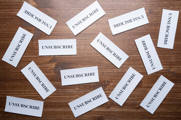 Some tickets with the word Unsubscribe arranged on the table, as a concept of the choice to cancel...