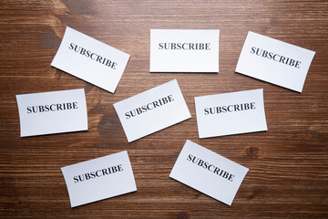 Some tickets with the word Subscribe arranged on the table, as a concept of the choice to subscribe	