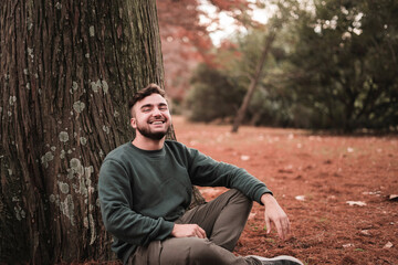 Obraz premium Portrait of a young Caucasian man in a park