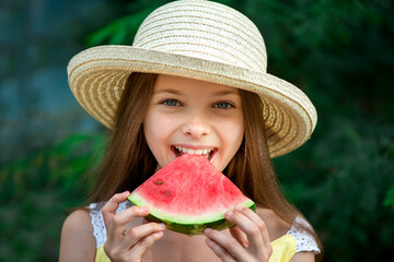 Smiling little girl with blue eyes with a slice of watermelon outdoor. Portrait of cute kid, summer season