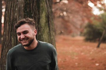 Portrait of a young Caucasian man in a park