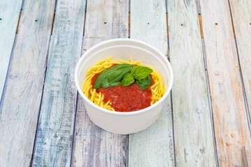 Home service bowl with spaghetti recipe with pomodoro sauce and basil